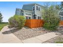 Townhome exterior showcasing a wood fence and rock garden for low-maintenance beauty at 5180 Buckingham Rd, Boulder, CO 80301