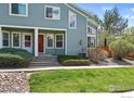 Charming townhome features a tidy lawn, rock garden, and a welcoming covered entryway at 5180 Buckingham Rd, Boulder, CO 80301