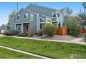 Attractive townhome with a well-manicured lawn, highlighted by a stone garden and quaint covered entrance at 5180 Buckingham Rd, Boulder, CO 80301