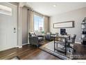 Bright home office featuring wood floors, a large window, comfortable seating and modern decor at 6531 14Th St, Frederick, CO 80530