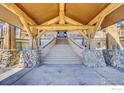 Inviting stone staircase leads to the grand entrance framed by exposed log beams and stone pillars at 6553 Sunshine Canyon Dr, Boulder, CO 80302