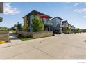 Modern home with a balcony and neat landscaping, enhancing its street appeal at 725 Amelia Ln, Lafayette, CO 80026