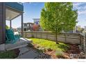 Inviting outdoor space featuring a well-maintained lawn, stone pathway, and comfortable seating at 725 Amelia Ln, Lafayette, CO 80026