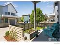 Charming fenced yard with manicured lawn and a cozy patio area with comfortable seating at 725 Amelia Ln, Lafayette, CO 80026