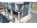 Multi-level townhome featuring modern architecture, multiple balconies, and outdoor seating at 7861 W 51St Ave, Arvada, CO 80002
