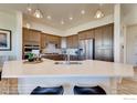 Modern kitchen featuring an island with quartz countertops, stainless steel appliances, and recessed lighting at 903 W 129Th Pl, Westminster, CO 80234