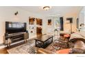 Inviting living room with hardwood floors, comfortable seating, and a view into the kitchen at 1136 Venice St, Longmont, CO 80501