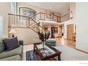 Grand foyer with a soaring ceiling, hardwood floors, and a staircase leading to the upper level at 14180 Whitney Cir, Broomfield, CO 80023