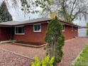 Brick home with manicured landscape, decorative rock and brick border at 1701 Jewel Dr, Longmont, CO 80501