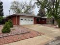 A cozy brick home featuring a two-car garage and low-maintenance landscaping at 1701 Jewel Dr, Longmont, CO 80501
