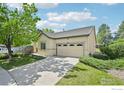 Well-maintained home with lush landscaping, a paved driveway, and an attached two-car garage at 2420 E 127Th Ave, Thornton, CO 80241