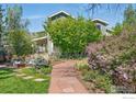 Beautiful home with a well-manicured yard, stone steps, and colorful flowers at 3059 6Th St, Boulder, CO 80304
