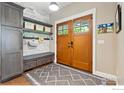 Cozy foyer with convenient storage bench, shelving, and a double-door entry at 3059 6Th St, Boulder, CO 80304