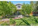 Inviting home featuring a covered porch, mature landscaping, and a brick walkway at 3059 6Th St, Boulder, CO 80304