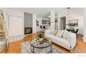 Cozy living room with fireplace, modern decor, and open layout to the kitchen and dining area at 3515 28Th St # 201, Boulder, CO 80301