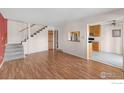Bright living room featuring wood floors, staircase and open to the kitchen at 3740 Iris Ave # B, Boulder, CO 80301