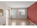 Cozy living room featuring wood floors, a big window, and a door to backyard at 3740 Iris Ave # B, Boulder, CO 80301