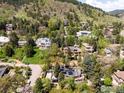 Panoramic aerial view captures the home's setting in a lush neighborhood, with mountain views in the distance at 505 Geneva Ave, Boulder, CO 80302
