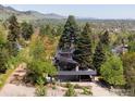 Aerial view of the modern home nestled amongst mature trees, showcasing its architectural design and serene surroundings at 505 Geneva Ave, Boulder, CO 80302