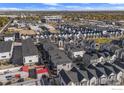 Panoramic aerial view showcasing a neighborhood of modern townhomes with the cityscape in the distance at 5173 Vivian St, Wheat Ridge, CO 80033