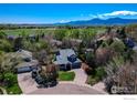 Overhead view of a suburban home nestled among mature trees, offering mountain views in a desirable neighborhood at 5978 Scotswood Ct, Boulder, CO 80301