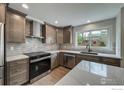 Well-appointed kitchen with stainless appliances, ample cabinets, and stylish backsplash at 5978 Scotswood Ct, Boulder, CO 80301