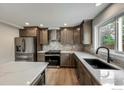 Gourmet kitchen featuring modern appliances, sleek countertops, and lots of storage at 5978 Scotswood Ct, Boulder, CO 80301
