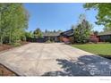 Contemporary home featuring a sprawling driveway and modern landscaping at 6862 Roaring Fork Trl, Boulder, CO 80301