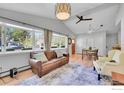 Bright living room featuring vaulted ceilings, large windows, and hardwood floors at 714 S Longmont Ave, Lafayette, CO 80026
