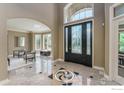 Grand foyer with a decorative tiled floor, high ceilings, arched doorway, and plenty of natural light at 725 E Wiggins St, Superior, CO 80027