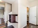 Bright entryway featuring hardwood floors, convenient storage niche, and access to a half bathroom at 920 Wagon Bend Rd, Berthoud, CO 80513