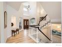 Bright foyer featuring hardwood floors, a grand staircase, and high ceilings at 933 Xenon Ct, Golden, CO 80401