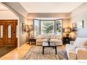Cozy living room with a bay window, light-colored furniture, and hardwood floors at 933 Xenon Ct, Golden, CO 80401