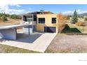 Modern two-story house with unique design features, a driveway, and attached garage at 987 Lost Angel Rd, Boulder, CO 80302