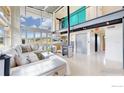 Spacious living room featuring a modern fireplace, large windows with mountain views, and stylish decor at 987 Lost Angel Rd, Boulder, CO 80302