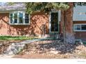 Close-up of the front entrance with brick exterior, steps, and a decorative door at 10547 Lipan St, Northglenn, CO 80234