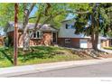 Two-story home with brick and siding, mature trees, and a well-manicured lawn at 10547 Lipan St, Northglenn, CO 80234