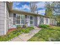 Inviting front yard featuring a sidewalk, lush landscaping, and attractive exterior details at 1201 Stein St, Lafayette, CO 80026
