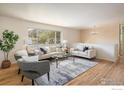 Bright living room featuring hardwood floors, a large window, and stylish, neutral furniture at 1270 Berea Dr, Boulder, CO 80305