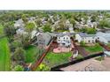 Aerial view of a home with a backyard oasis, solar panels, fenced yard, patio, and lawn at 13106 Elizabeth St, Thornton, CO 80241