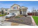 Charming two-story home with well-maintained front yard, attached garage, and covered porch at 13106 Elizabeth St, Thornton, CO 80241