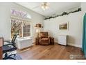 Bright office featuring a large window, hardwood floors, and cozy seating for a comfortable work space at 13668 Plaster Cir, Broomfield, CO 80023