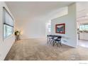 Bright living room with plush carpeting, a large window, and an open floor plan at 1506 Fisk Ct, Longmont, CO 80503