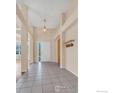 Bright foyer with tiled flooring, high ceilings, and a pendant light fixture at 1606 Iris St, Broomfield, CO 80020