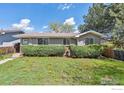 Charming single story home with a beautifully landscaped front yard and walkway at 200 Perry St, Denver, CO 80219