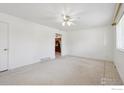 Bright living room with tiled flooring, ceiling fan, and fresh white paint at 200 Perry St, Denver, CO 80219