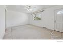 Bright living room with tiled flooring, ceiling fan, and fresh white paint at 200 Perry St, Denver, CO 80219