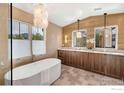 Luxurious bathroom featuring a soaking tub, dual vanities, modern lighting and mountain views at 2700 15Th St, Boulder, CO 80304
