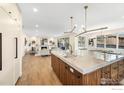 Open concept kitchen featuring a stone countertop island flowing into the living and dining areas at 2700 15Th St, Boulder, CO 80304