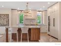Modern kitchen with a large center island, stainless steel appliances, and contemporary light fixture at 2700 15Th St, Boulder, CO 80304
